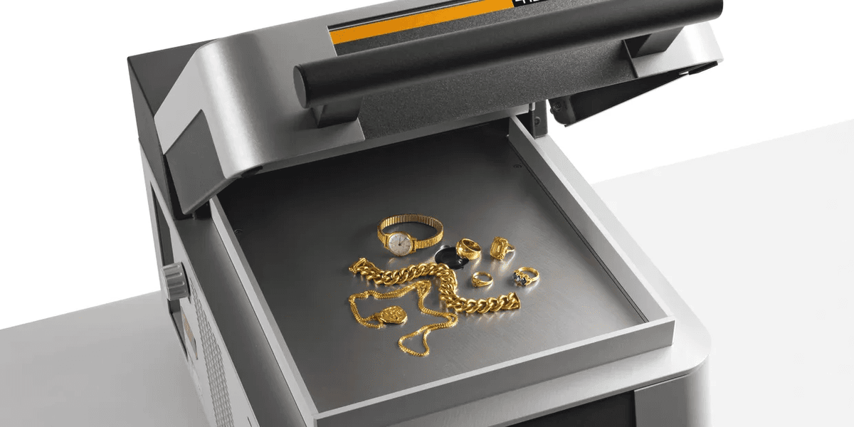 Precision analytical balance with gold jewelry and bullion in a modern laboratory