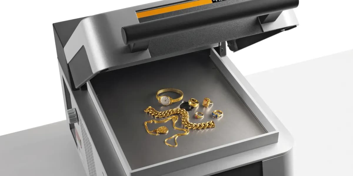 Precision analytical balance with gold jewelry and bullion in a modern laboratory
