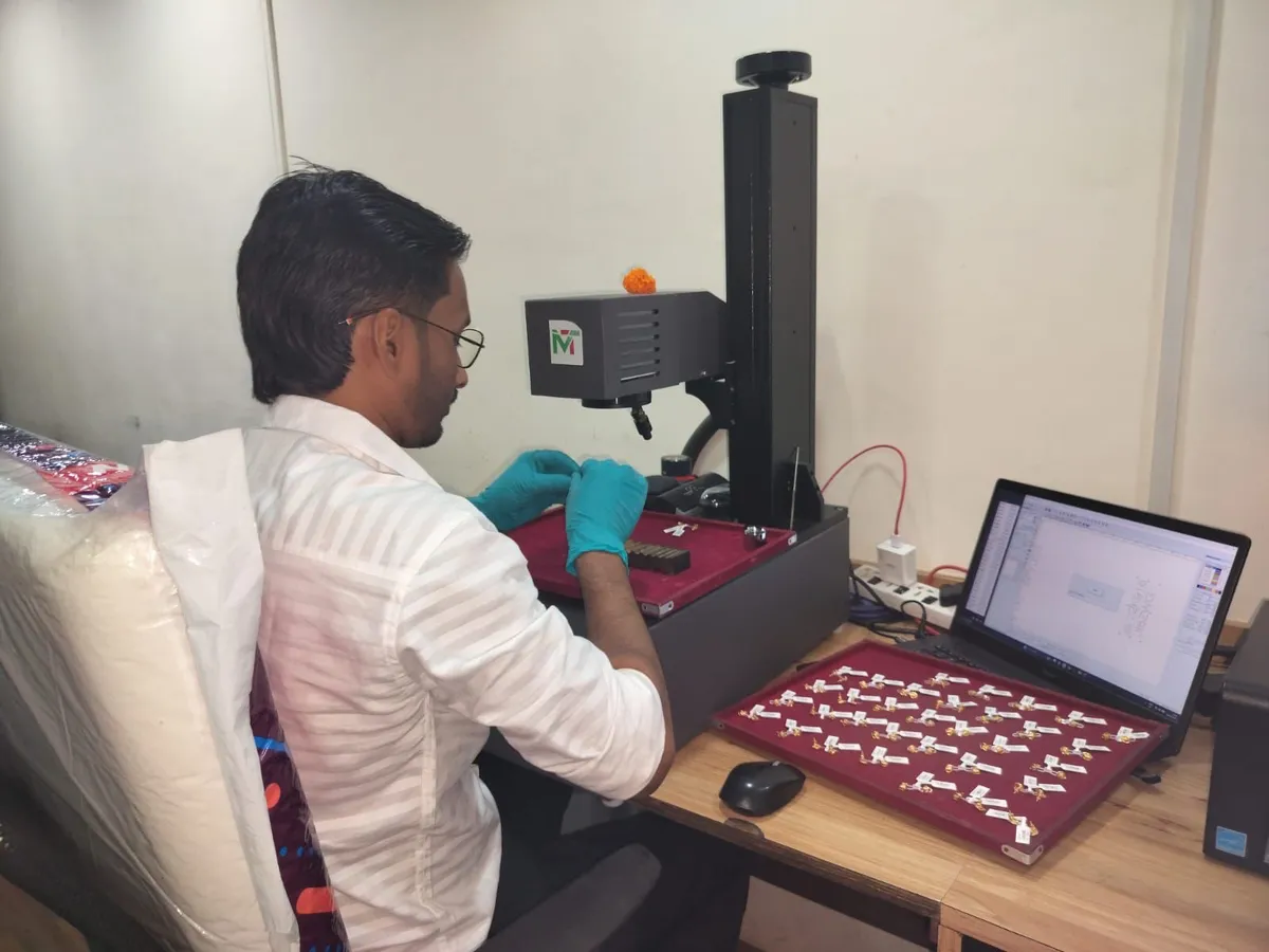 Technician laser-engraving HUID on gold jewellery at Varsha Bullion Hallmarking Centre